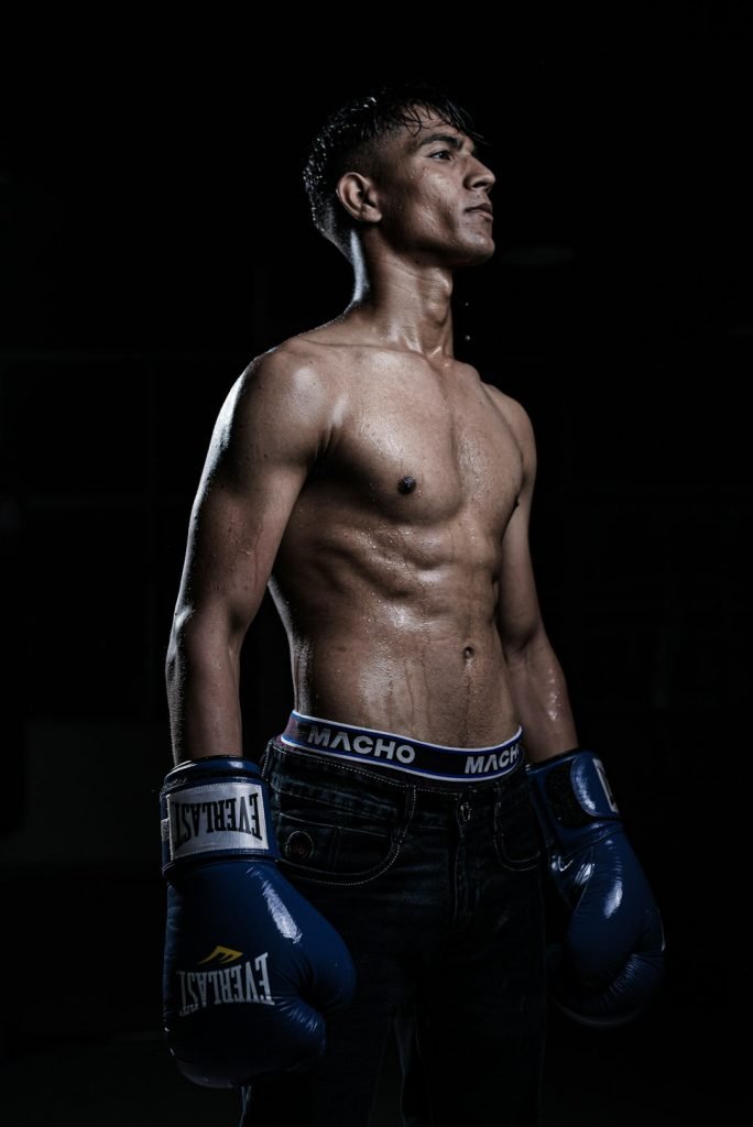 a-man-with-no-shirt-wearing-boxing-gloves-xfoinbv82a